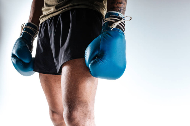 Boxers figure wearing blue boxing gloves and shorts - Фото, изображение