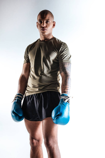 Strong young man wearing new boxing equipment - Foto, Imagem