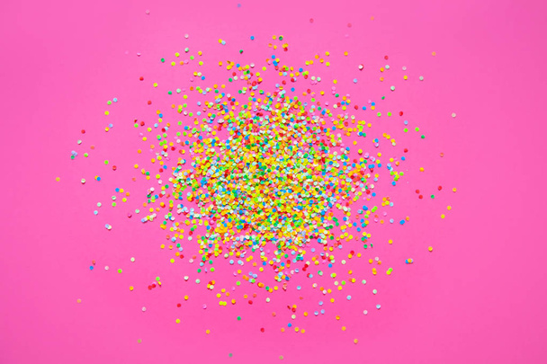Frame made of colored confetti. Pink background.  - Foto, Bild