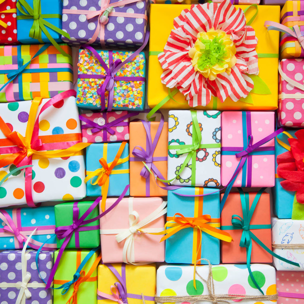 Colored gift boxes with colorful ribbons. White background. Gifts for Christmas or a birthday. - 写真・画像