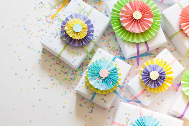 White gifts. Bright satin ribbons. Colorful rosettes like decorating boxes. - Photo, image