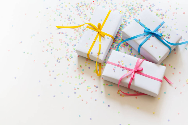 Boxes for gifts of white color. Colored satin ribbons. White background. - Fotó, kép