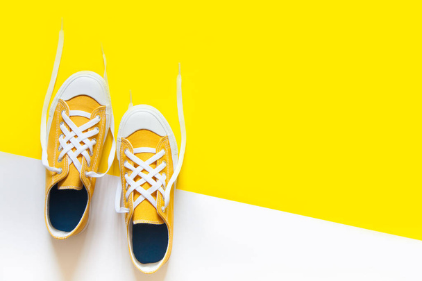 Short low  bright sneakers on a yellow background. - Foto, Imagem