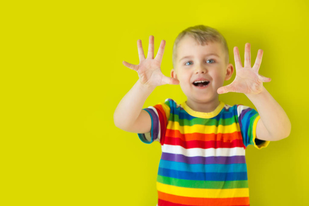 A joyful, cheerful, smiling child stretched out his palms forwar - Фото, зображення