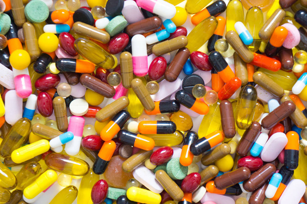 colored pills on a white background. - Φωτογραφία, εικόνα