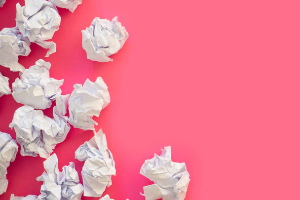 Crumpled sheets of white paper ball. A lot of trash paper. Pink  - Фото, изображение