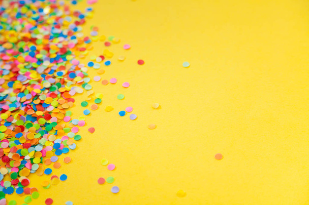 Round frame made of colored confetti. White background. Festive  - Zdjęcie, obraz