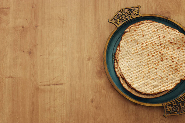 Pesah celebration concept (jewish Passover holiday). Translation for Hebrew Text over plate (Matzah) Matza - Fotó, kép