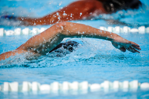 Details with a professional athlete swimming in an olympic swimm - Foto, afbeelding