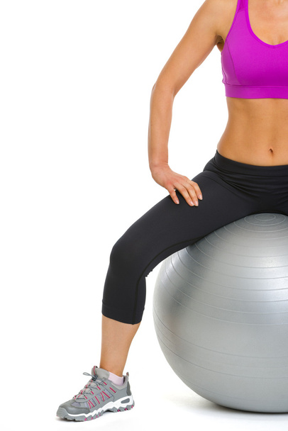 Closeup on slim young woman sitting on fitness ball - Fotó, kép