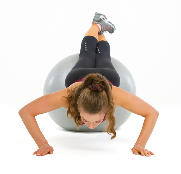 Fitness young woman doing push ups on fitness ball - Photo, image