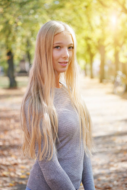 outdoor portrait of blond young woman enjoying sunny day - Photo, Image