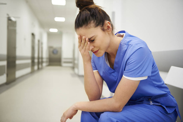 Female nurse suffering from headache  - Фото, зображення