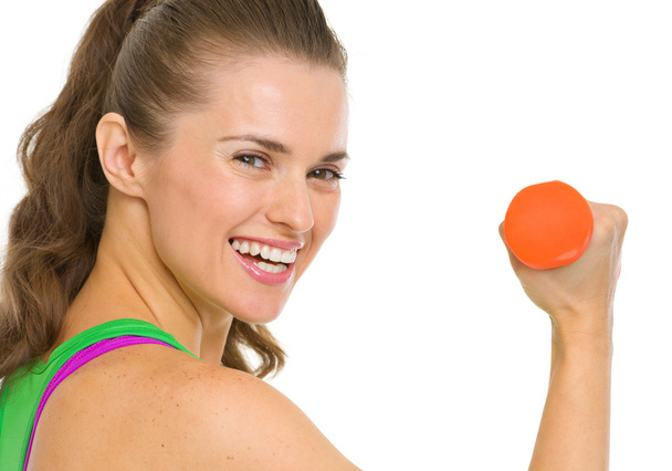 Portrait of smiling fitness young woman with dumbbell - Φωτογραφία, εικόνα