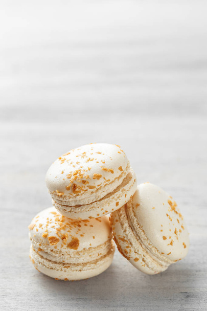 Stack of white praline macarons on grey background - Zdjęcie, obraz