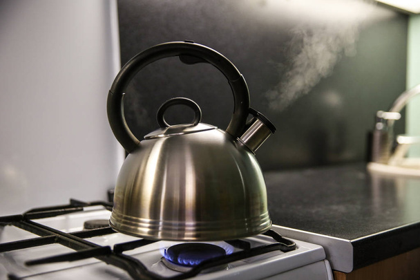 kettle with boiling water. the kettle boils on a gas stove. the kettle whistles on the gas. steam from the kettle through the whistle. - Photo, Image