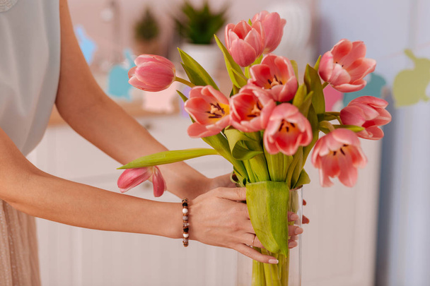 Close up of female hands that holding flowers - Fotó, kép