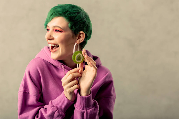 Nice green haired woman touching a lollipop - Zdjęcie, obraz