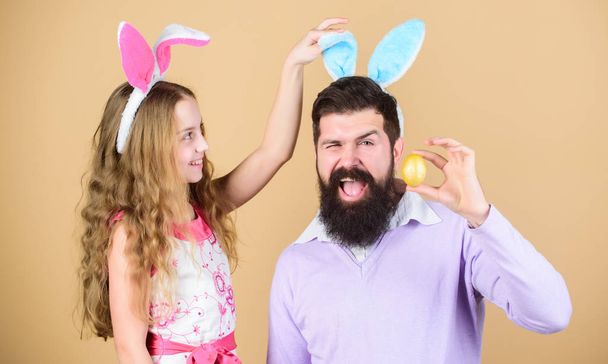 Holiday bunny long ears. Family tradition concept. Dad and daughter wear bunny ears. Father and child celebrate easter. Spring holiday. Easter spirit. Easter activities for whole family. Happy easter - Valokuva, kuva