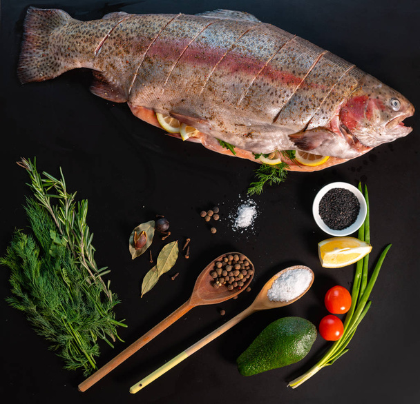 Culinary still life with fresh trout and seasoning - Fotoğraf, Görsel