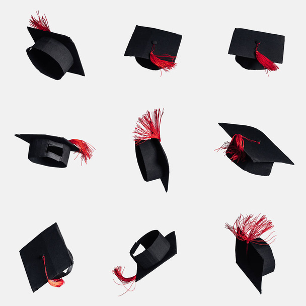 Black academic caps with red tassels isolated on white - Фото, изображение