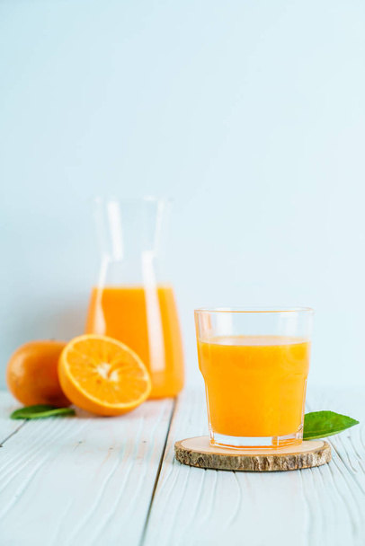 Fresh orange juice on wood background - Фото, зображення
