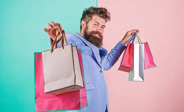 Enjoy shopping black friday. Hipster shopping with discount. Man bearded hipster businessman formal suit carry paper shopping bags. Buy gifts for everyone. Ready for holiday. Buy gifts in advance - Foto, Bild