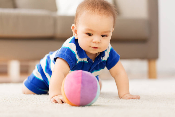sweet little asian baby boy playing with toy ball - Фото, зображення