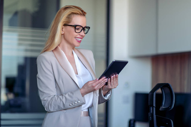  Young modern businesswoman holding tablet. - Photo, Image