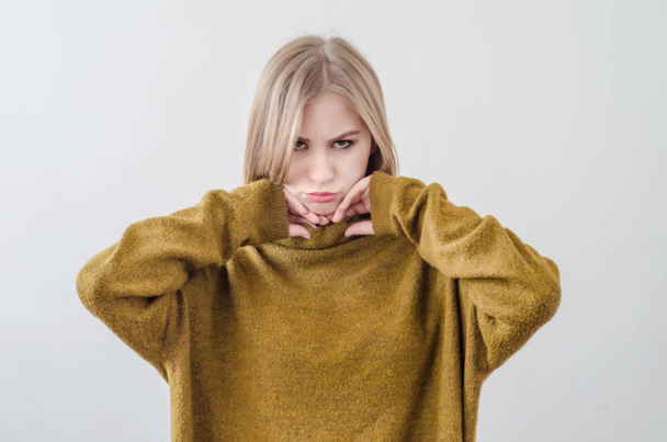 Girl in a green sweater posing on a white background. Offended,  - Fotografie, Obrázek