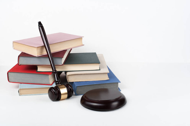 Law concept open book with wooden judges gavel on table in a courtroom or law enforcement office, white background. Copy space for text - Photo, Image