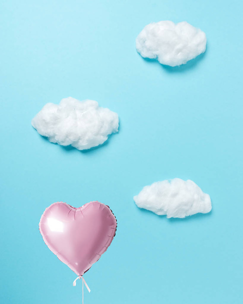 White cotton clouds with pink heart balloon on pastel blue background. Minimal concept. - Φωτογραφία, εικόνα