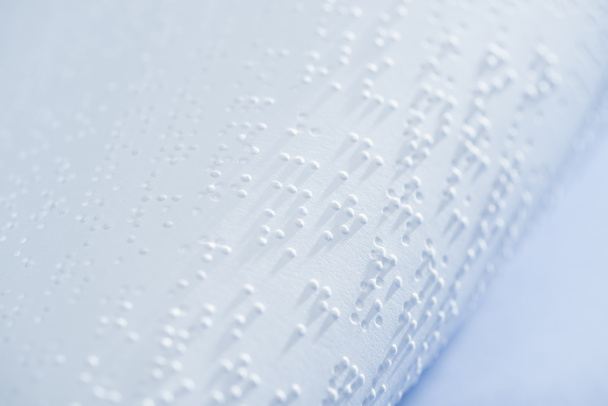 selective focus of text in braille code on white paper with copy space - Foto, imagen