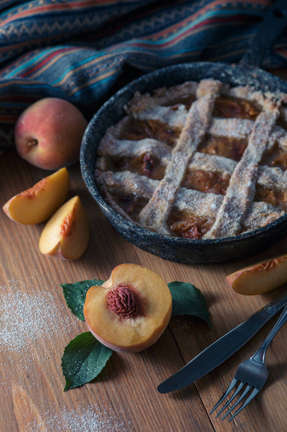 Fresh homemade peach pie on table with fresh fruit - Фото, зображення