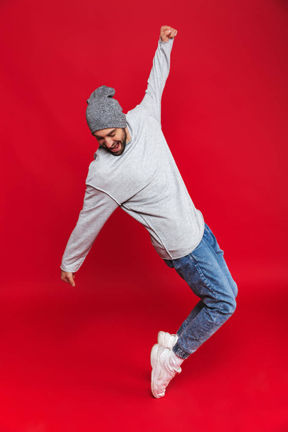 Full length photo of joyful man smiling and jumping isolated ove - Φωτογραφία, εικόνα