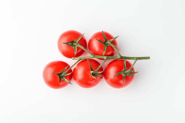 top view of branch of cherry tomatoes on white background - Fotó, kép