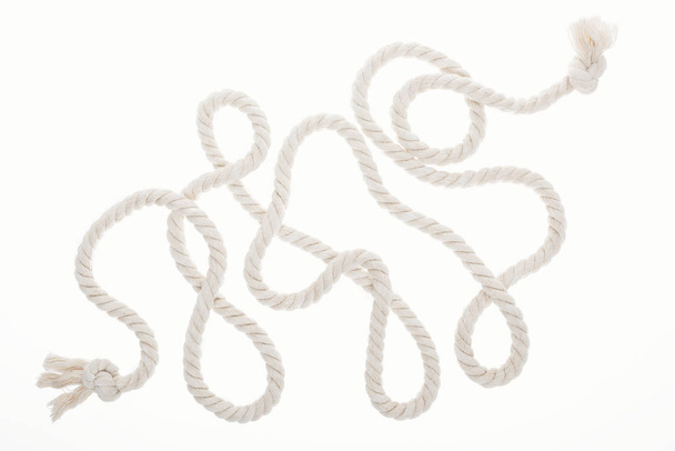 long white rope with curls and knots isolated on white  - Foto, Bild