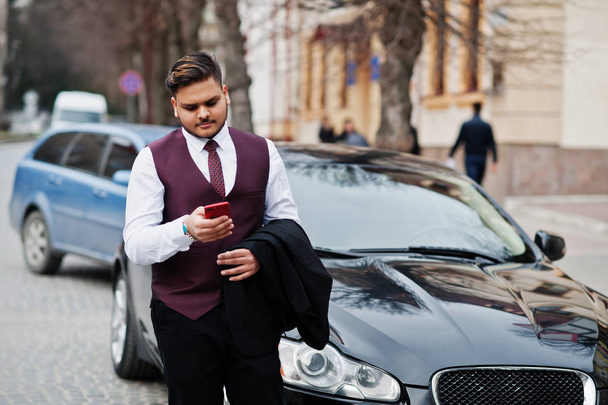 Stylish indian businessman in formal wear with mobile phone stan - Photo, image
