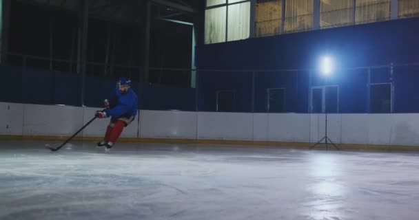 Hockey toekomen uitvoering een puck, schaatsen verleden een tegengestelde verdediger en het nemen van een slap shot doelman te voorkomen dat het scoren van een goal door het vangen van de puck - Video