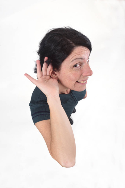 woman putting a hand on her ear because she can not hear on whit - Photo, Image