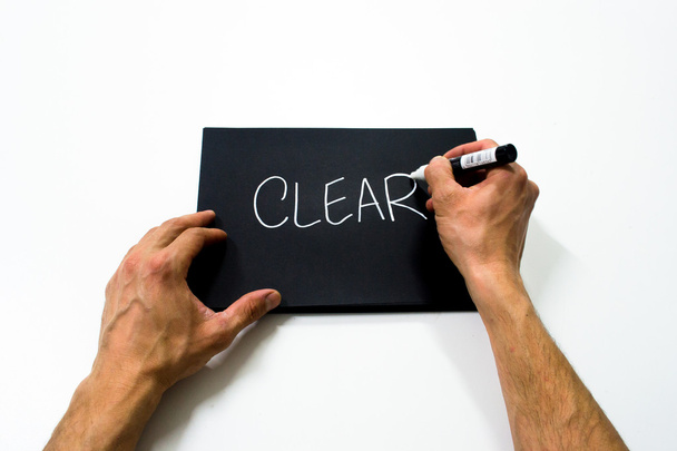 twee hand schrijven "clear" op een zwarte achtergrond - Foto, afbeelding