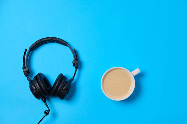 Music or podcast background with headphones and cup of coffee on - Foto, Imagem