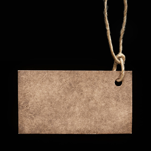 Blank label on a black background, tag attached to the product r - Fotografie, Obrázek