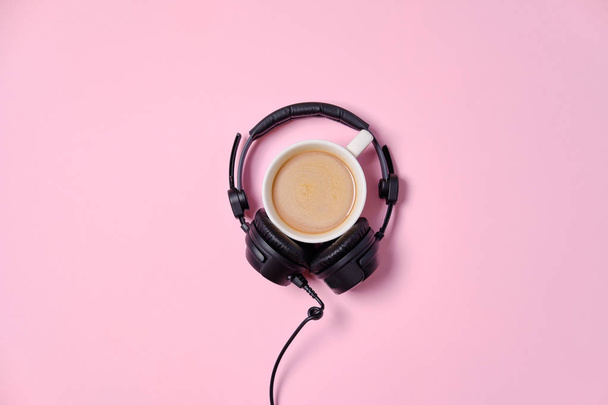 Music or podcast background with headphones and cup of coffee on - Fotó, kép