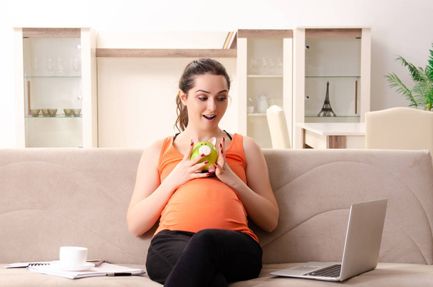 Giovane donna incinta che lavora a casa
 - Foto, immagini