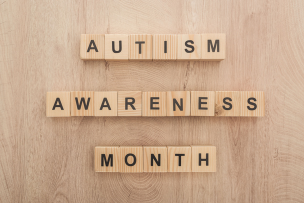 top view of autism awareness month words made of wooden blocks  - Photo, Image