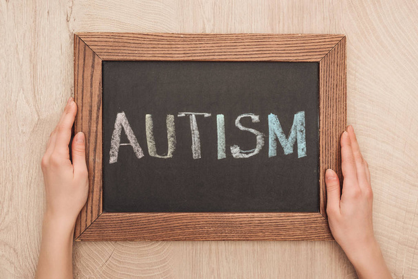 cropped view of woman holding chalkboard with autism lettering  - Photo, Image