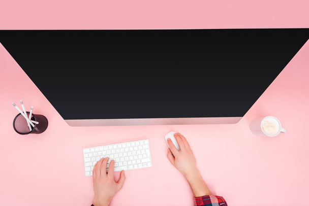 cropped view of man using computer on pink background - Photo, image