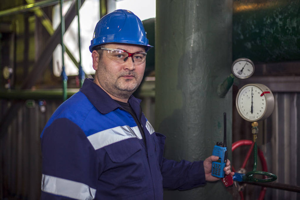 Fontanero inspecciona tuberías para la instalación de calor; El mecánico - el
 - Foto, Imagen