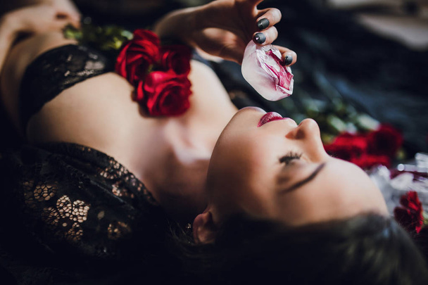 young woman in black lingerie posing with red rose frozen in ice - Valokuva, kuva